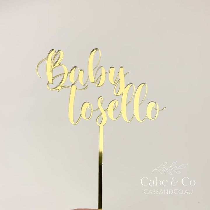 Gold metallic acrylic cake topper with the words &