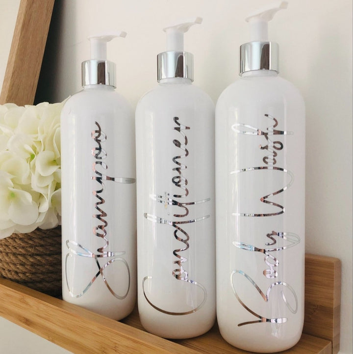 Silver accented white plastic pump bottles for shampoo, conditioner and body wash.  Fully personalised bottles.