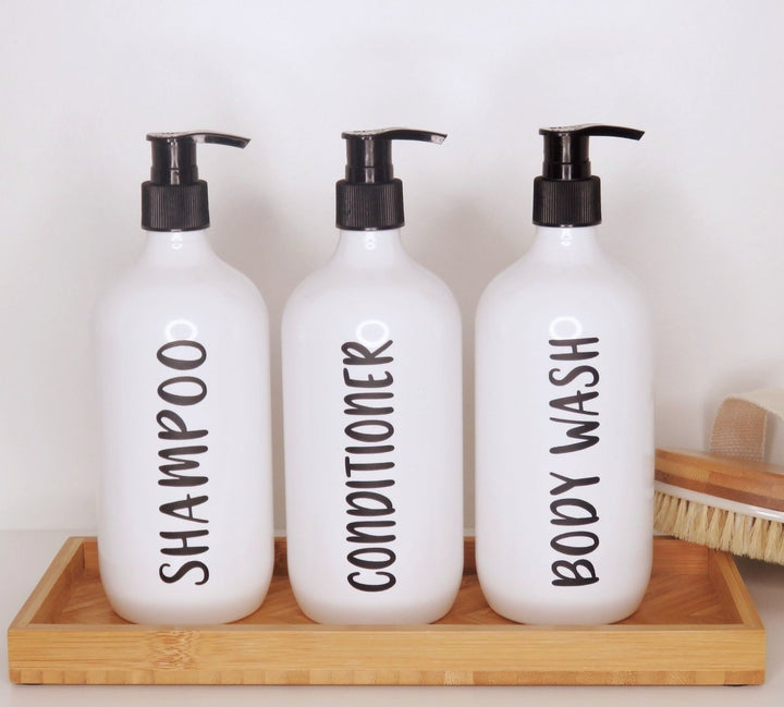 White bathroom shower pump bottles for hand lotion and shower gel.